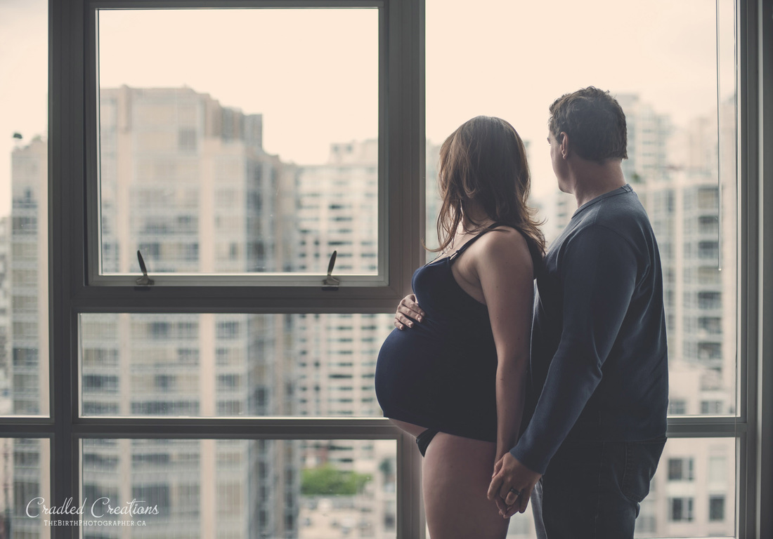 Pregnant couple looking at a Vancouver view